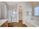 Bright bathroom features a walk-in shower and soaking tub next to the walk-in closet entrance at 983 Cutter St, Henderson, NV 89011