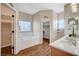 Bright bathroom boasts a soaking tub, tiled floors, and walk-in closet entrance at 983 Cutter St, Henderson, NV 89011