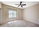 A naturally lit bedroom features carpeted floors, ceiling fan, and large window at 983 Cutter St, Henderson, NV 89011