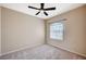 Cozy bedroom with neutral walls, plush carpet, and a ceiling fan at 983 Cutter St, Henderson, NV 89011