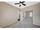 Bright bedroom features a ceiling fan, plush carpet, and mirrored closet doors at 983 Cutter St, Henderson, NV 89011
