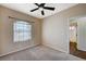 Bright bedroom features a ceiling fan, plush carpet, and an ensuite bathroom entrance at 983 Cutter St, Henderson, NV 89011