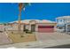 Charming one-story home featuring desert landscaping, a tile roof and a brick driveway leading to a spacious two-car garage at 983 Cutter St, Henderson, NV 89011
