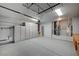 Spacious garage with ample storage cabinets, overhead racks, and epoxy flooring at 983 Cutter St, Henderson, NV 89011