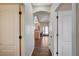Hallway leads into a living area featuring wood floors and white doors at 983 Cutter St, Henderson, NV 89011