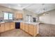 Open kitchen featuring wood cabinets, an island, and direct access to the living room and outdoor space at 983 Cutter St, Henderson, NV 89011