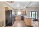 Bright kitchen with stainless appliances, custom tile backsplash, and a cozy breakfast bar with tile floors at 983 Cutter St, Henderson, NV 89011