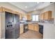 Well-equipped kitchen featuring stainless appliances, tile backsplash, and ample counter space and storage at 983 Cutter St, Henderson, NV 89011