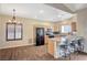 Kitchen with wooden cabinets, tile backsplash, stainless appliances and a bar that seats three at 983 Cutter St, Henderson, NV 89011