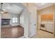 Living room next to laundry room features a cozy fireplace and wood-look floors at 983 Cutter St, Henderson, NV 89011