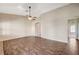 Open living room with tile flooring leading to doorways to other rooms with vaulted ceilings and ceiling fan at 983 Cutter St, Henderson, NV 89011