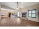 Open living space with tile floors, gas fireplace, vaulted ceilings, and adjoining kitchen with breakfast bar at 983 Cutter St, Henderson, NV 89011