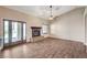 Gas fireplace nestled in open living space with french doors leading to outside and tile floors at 983 Cutter St, Henderson, NV 89011