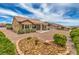 A backyard with desert landscaping, a patio cover, and mountain views at 10421 Linfield Pl, Las Vegas, NV 89134