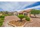 Landscaped backyard features desert plants and gravel, perfect for low-maintenance living at 10421 Linfield Pl, Las Vegas, NV 89134