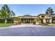 Community theater building with mature trees and landscaping near the entrance at 10421 Linfield Pl, Las Vegas, NV 89134