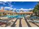 Large community pool with plenty of lounge chairs, surrounded by desert landscaping at 10421 Linfield Pl, Las Vegas, NV 89134