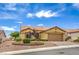 Charming home with a two-car garage, desert landscaping, and a well-manicured lawn at 10421 Linfield Pl, Las Vegas, NV 89134