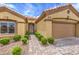 Inviting home exterior featuring a paved walkway, desert landscaping and two car garage at 10421 Linfield Pl, Las Vegas, NV 89134