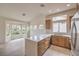 Bright kitchen features an island, stainless steel appliances, and a breakfast nook overlooking the landscaped backyard at 10421 Linfield Pl, Las Vegas, NV 89134
