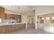 Modern kitchen features stainless steel appliances, wooden cabinets, tile floors, and a sliding glass door at 10421 Linfield Pl, Las Vegas, NV 89134