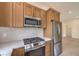 Modern kitchen with stainless steel appliances, gas range, and stylish wood cabinets at 10421 Linfield Pl, Las Vegas, NV 89134
