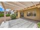 An outdoor patio area featuring a pergola, tile flooring and access to the beautifully landscaped backyard at 10421 Linfield Pl, Las Vegas, NV 89134