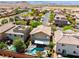An aerial view shows lush landscaping, a refreshing pool, and a covered patio at 10474 Palmadora St, Las Vegas, NV 89178