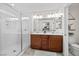 Bright bathroom with double sink vanity, toilet, and glass-enclosed shower at 10474 Palmadora St, Las Vegas, NV 89178
