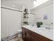 Bathroom featuring a double sink vanity, toilet, and shower with a white shower curtain at 10474 Palmadora St, Las Vegas, NV 89178