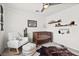 Cozy Bedroom featuring a rocking chair, crib, and decorative wall shelves and art at 10474 Palmadora St, Las Vegas, NV 89178