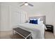 Comfortable bedroom features neutral tones, a ceiling fan, and a sliding closet door at 10474 Palmadora St, Las Vegas, NV 89178