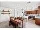 Dining area with wood table, modern lighting, and view of the kitchen at 10474 Palmadora St, Las Vegas, NV 89178
