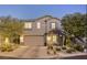 Charming two-story home with a well-manicured front yard and an attached two-car garage at 10474 Palmadora St, Las Vegas, NV 89178