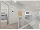 Hallway with decorative railing, leading to a living room and other rooms at 10474 Palmadora St, Las Vegas, NV 89178