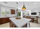 Modern kitchen with stainless steel appliances, center island, and dining area at 10474 Palmadora St, Las Vegas, NV 89178