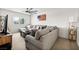 Cozy living room with a large sectional sofa, ceiling fan, and a view of the neighborhood at 10474 Palmadora St, Las Vegas, NV 89178