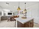 Open-concept living space with kitchen island, dining area, and comfortable seating at 10474 Palmadora St, Las Vegas, NV 89178