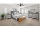 Bright main bedroom with neutral tones, a ceiling fan, and a tufted headboard at 10474 Palmadora St, Las Vegas, NV 89178