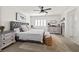 Bright main bedroom with neutral tones, a ceiling fan, and a tufted headboard at 10474 Palmadora St, Las Vegas, NV 89178