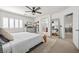 Spacious main bedroom with ceiling fan, dresser, and ensuite bathroom entrance at 10474 Palmadora St, Las Vegas, NV 89178
