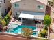 Aerial view of a backyard pool with a covered patio and lounge chairs at 10474 Palmadora St, Las Vegas, NV 89178
