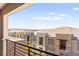 A balcony view featuring several residential townhomes with desert landscape under a bright, blue sky at 1103 Tektite Ave, Henderson, NV 89011