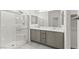 Bright bathroom featuring a glass enclosed shower and double sink vanity at 1103 Tektite Ave, Henderson, NV 89011