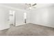 Bright bedroom featuring neutral carpet, ceiling fan and ensuite bathroom access at 1103 Tektite Ave, Henderson, NV 89011