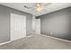 A bedroom featuring neutral carpeting, walls, and closet with white doors at 1103 Tektite Ave, Henderson, NV 89011