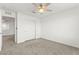 An empty bedroom featuring carpet floors, closet, ceiling fan, and entry into another room at 1103 Tektite Ave, Henderson, NV 89011