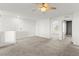 A large, brightly lit bonus room featuring a ceiling fan, carpet floors, and entry into another room at 1103 Tektite Ave, Henderson, NV 89011
