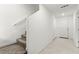 Hallway with tile floors, stairs, closet doors, and neutral walls at 1103 Tektite Ave, Henderson, NV 89011