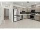Well-lit kitchen featuring stainless steel appliances and modern cabinets at 1103 Tektite Ave, Henderson, NV 89011